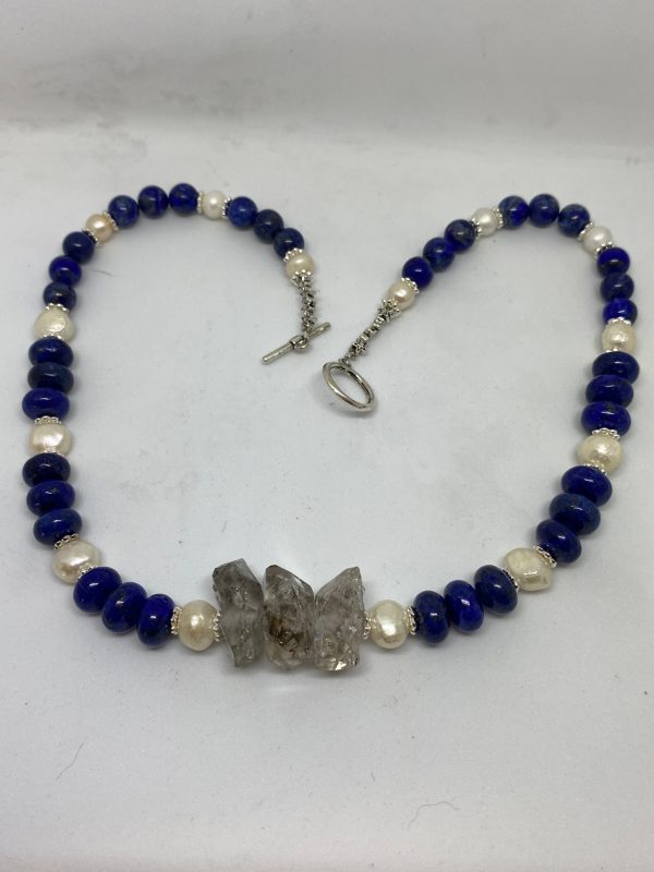 Lapis Lazuli, Herkimer Diamond, and Pearl Necklace. This necklace promotes Manifestation, Bliss, and Wisdom.