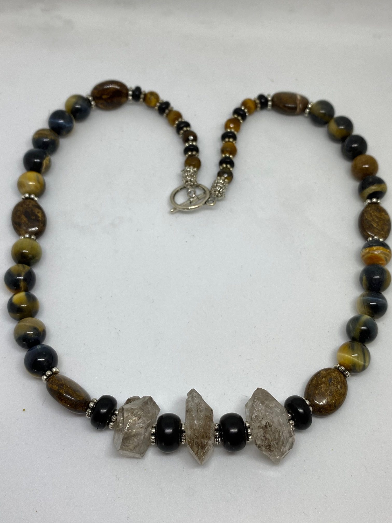 Blue Tiger Eye, Herkimer Diamond, Bronzite, and Jet Necklace. This necklace promotes Clear Communication, Psychic Development, Courage, and Protection. 