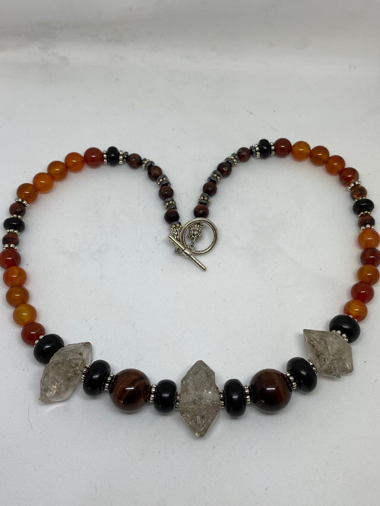 Red Tiger Eye, Herkimer Diamond, Jet, and Carnelian Necklace. This necklace promotes Happiness, Courage, Psychic Development, and Protection. 