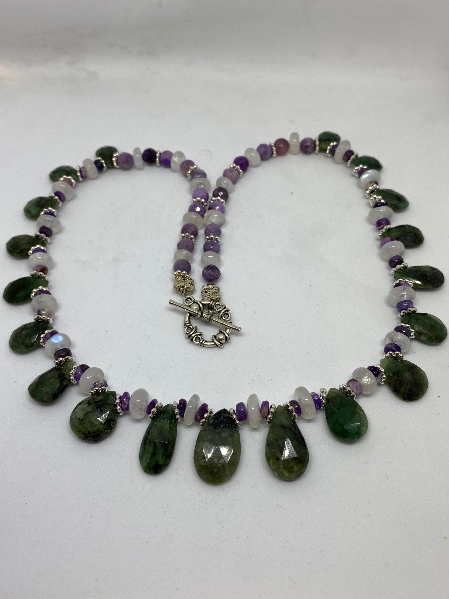 Emerald, Moonstone, and Sugilite Necklace This necklace supports Success, Good Fortune, and Your Inner Light.