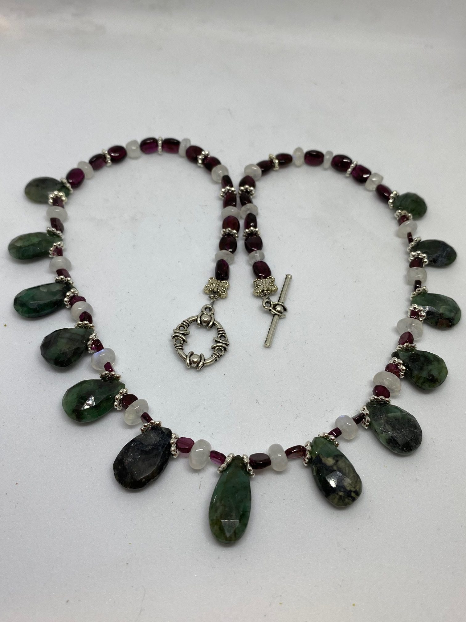 Emerald, Moonstone, and Garnet Necklace This necklace supports Success, Good Fortune, and Protection.