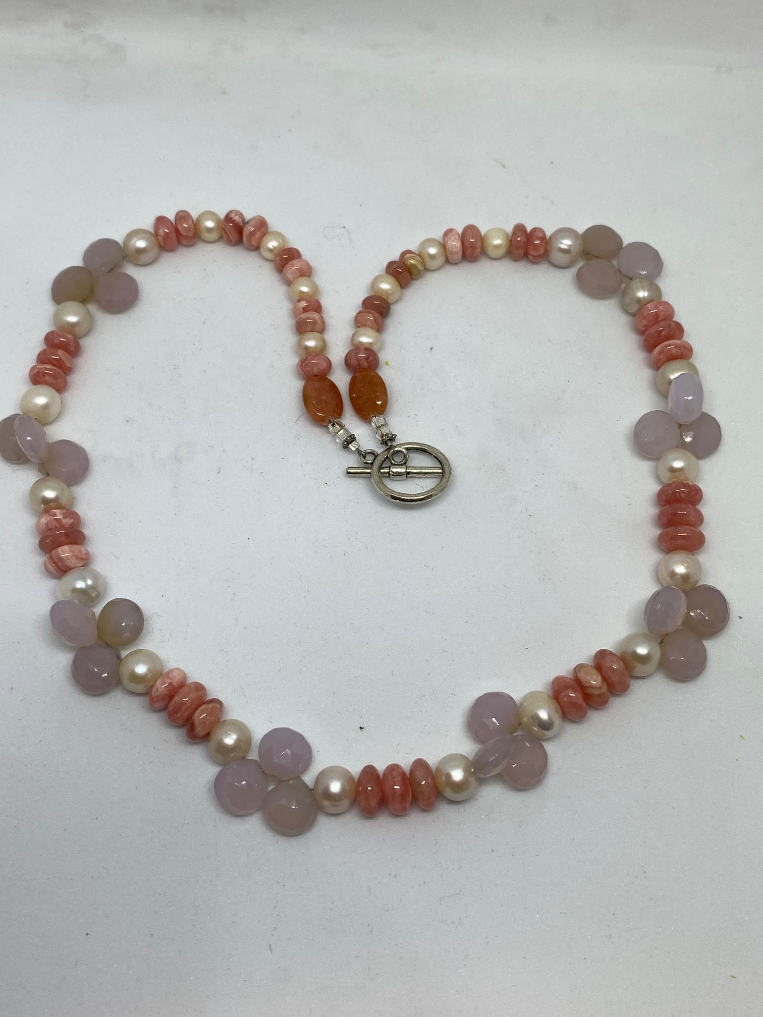 Rhodochrosite, Pearl, and Blue Chalcedony Necklace This necklace supports Joy, Integrity, and Goodwill. 